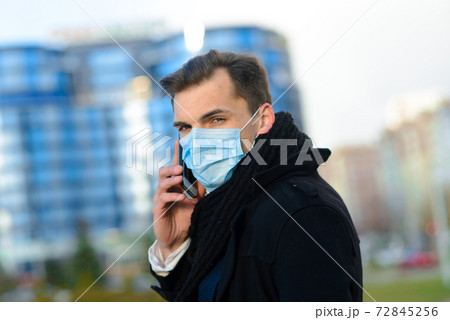 Portrait of young handsome businessman with face mask in quarantine of flu. Portrait of young handsome businessman with face mask in quarantine of flu. 72845256
