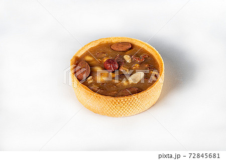 Shortcrust pastry tart with nuts and caramel on a light background. Home delivery. Festive concept. Quarantine. Shortcrust pastry tart with nuts and caramel on a light background. Home delivery. Festive concept. Quarantine. 72845681