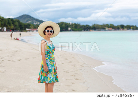 Asian middle aged woman relaxing at chaweng beach in koh samui ,Thailand. 72845867