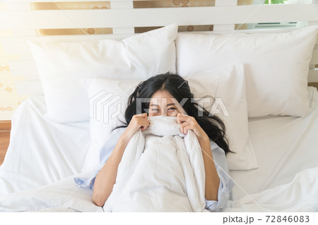 Top view of the beautiful Asian young woman in bed under the blanket. Top view of the beautiful Asian young woman in bed under the blanket. 72846083