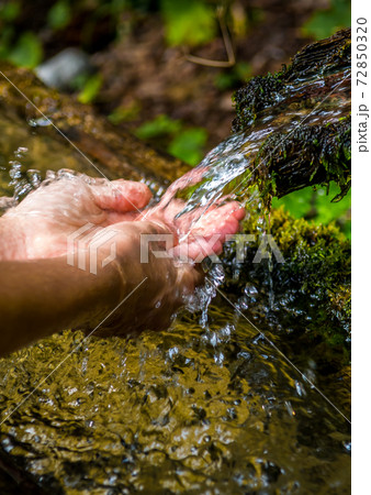 Washing Hands And Drink From A Spring With Clear And Cold Mountain Water 72850320