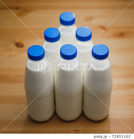 milk bottles on wooden table milk bottles on wooden table 72855102
