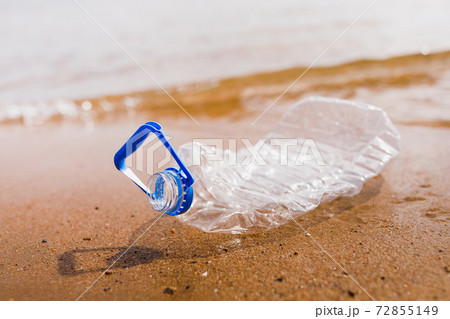wasted plastic bottle on beach 72855149