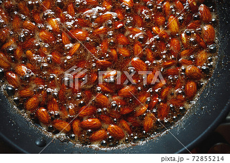 roasted almonds with cinnamon sugar cooking process, top view close-up 72855214