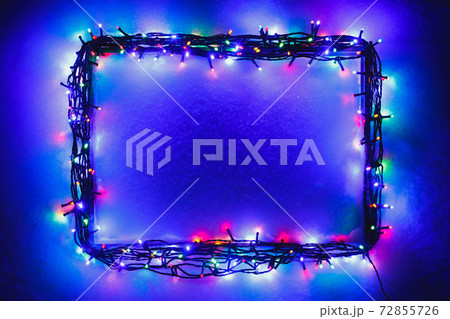 Christmas lights frame on snow background, blue and purple color Christmas lights frame on snow background, blue and purple color 72855726
