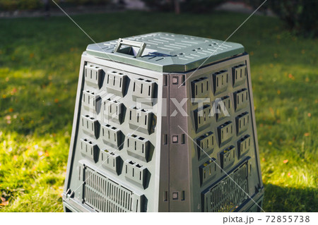 compost bin on green grass background 72855738
