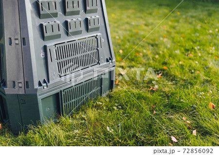 compost bin on green grass background 72856092