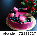 Delicious cake with fresh strawberries, raspberries, blueberry, currants. cut piece of cake and blade on wooden background. 72858727