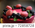 Delicious cake with fresh strawberries, raspberries, blueberry, currants. cut piece of cake and blade on wooden background. 72858728