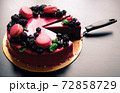 Delicious cake with fresh strawberries, raspberries, blueberry, currants. cut piece of cake and blade on wooden background. 72858729
