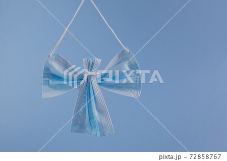 Angel made from face protection mask on blue background. Christmas concept pn pandemic. 72858767