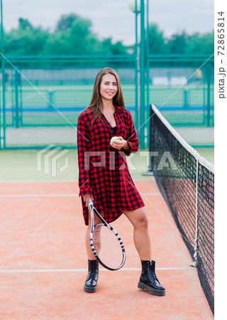 Beautiful stylish sexy woman in black trendy sportswear on tennis court. 72865814