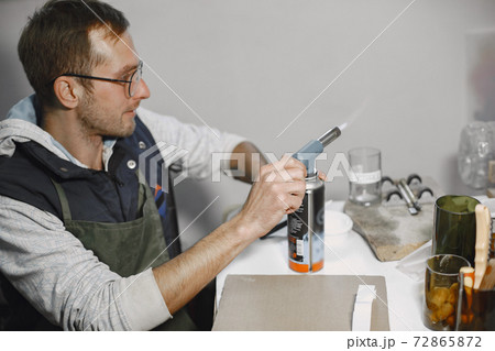 A man processes a bottle into a glass A man processes a bottle into a glass 72865872