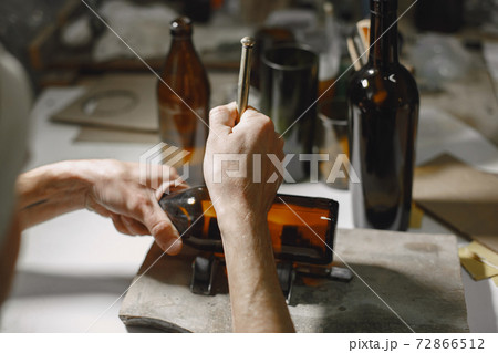 A man processes a bottle into a glass A man processes a bottle into a glass 72866512