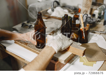 A man processes a bottle into a glass A man processes a bottle into a glass 72866676