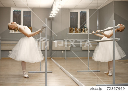Ballerina posing in front of white background Ballerina posing in front of white background 72867969