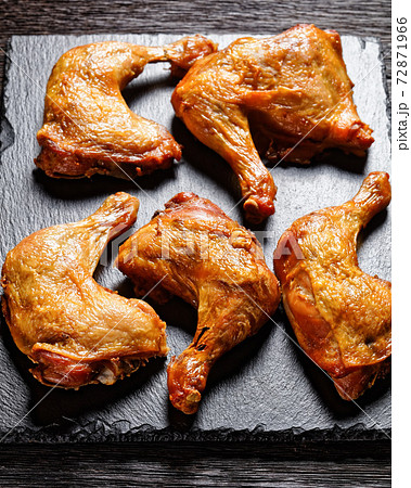 roast chicken legs on a stone tray, top view 72871966