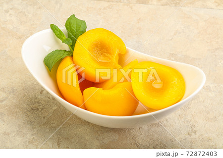 Sweet ripe canned peaches with mint Sweet ripe canned peaches with mint 72872403