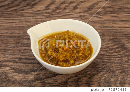 Green spicy sauce in the bowl 72872411