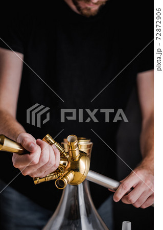 A turkish man show the methode of how to set up a hookah 72872906