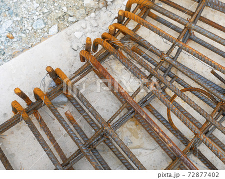 SEREMBAN, MALAYSIA -MARCH 29, 2020: Construction workers fabricating steel reinforcement bar at the construction site. They tied it together using the tiny wires before cover it up using formworks.  72877402