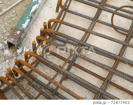 SEREMBAN, MALAYSIA -MARCH 29, 2020: Construction workers fabricating steel reinforcement bar at the construction site. They tied it together using the tiny wires before cover it up using formworks.  72877403