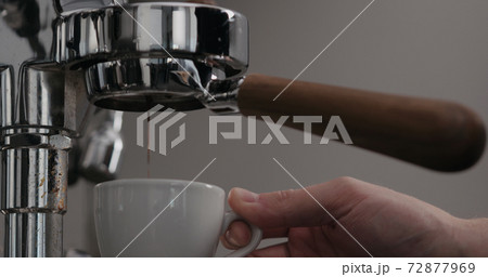low angle shot man making espresso with coffee machine low angle shot man making espresso with coffee machine 72877969