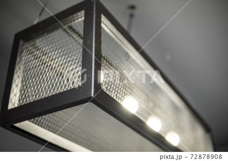 Modern design metal black lamp in a cube form from a metal profiles. Modern loft interior design. 72878908