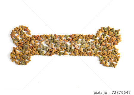 Pet food is laid out in the form of a bone on a white background. Pets, animal feeding. Special diet, training nutrition. Top view background Pet food is laid out in the form of a bone on a white background. Pets, animal feeding. Special diet, training nutrition. Top view background 72879645