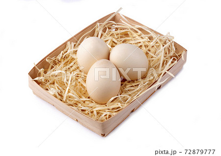 Three chicken eggs in a box on a white background 72879777
