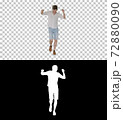 Cheerful young man in casual clothes dancing happily while walki 72880090