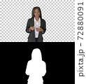 African American businesswoman explaining and gesturing while wa 72880091