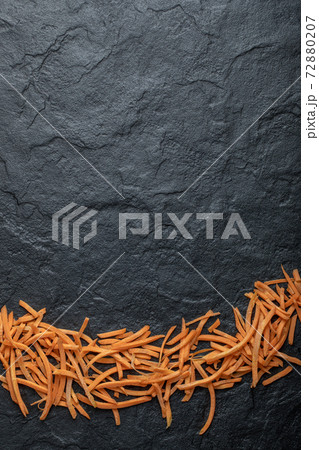 Close up Julienne of fresh organic carrot over black background 72880207