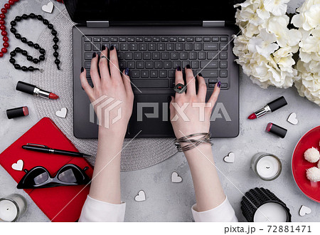 Beautiful groomed woman's hands typing at keyboard on the home office table 72881471