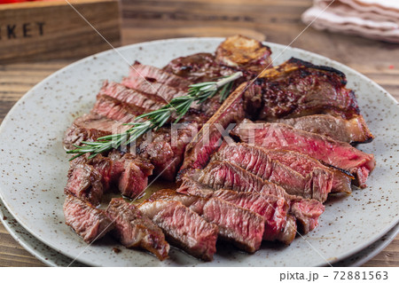 grilled red beef pork meat barbecue steak fillet with rosemary sprig and hot sauce served on plate 72881563