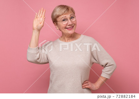 Beautiful caucasian woman waiving saying hello happy and smiling, friendly welcome gesture. Beautiful caucasian woman waiving saying hello happy and smiling, friendly welcome gesture. 72882184