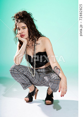 Young woman with brown hair on green 72882825