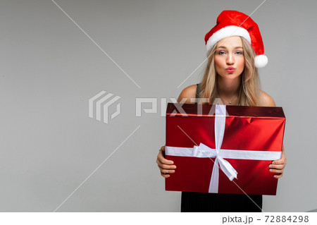 cheerful woman in black dress and cristmas hat cheerful woman in black dress and cristmas hat 72884298