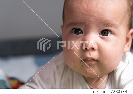 Childhood, happiness, motherhood concepts - Infant surprised, funny newborn child baby aged 3-4 months playing with toys, gnawing toothpicks on developmental mat lying on stomach at home indoors Childhood, happiness, motherhood concepts - Infant surprised, funny newborn child baby aged 3-4 months playing with toys, gnawing toothpicks on developmental mat lying on stomach at home indoors 72885349