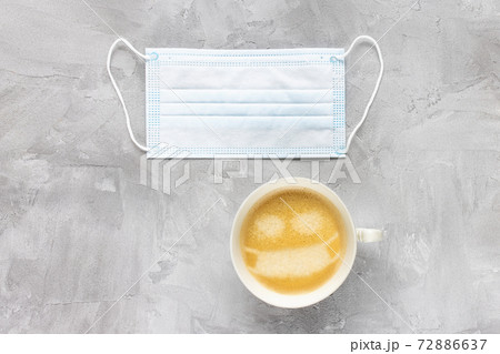 White medical face mask and cup of coffee White medical face mask and cup of coffee 72886637