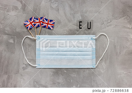 White medical face mask, UK flag and EU sign 72886638