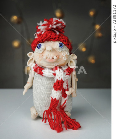 handmade toy made of polymer clay spirit of Christmas in knitted hat and scarf handmade toy made of polymer clay spirit of Christmas in knitted hat and scarf 72891172