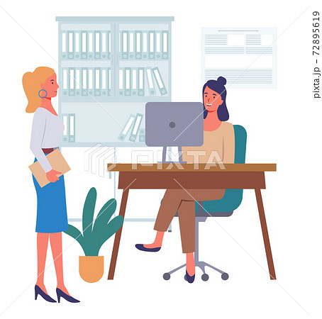Businesswomen dressed in formal clothes siting at the table with computer, standing in room, talking Businesswomen dressed in formal clothes siting at the table with computer, standing in room, talking 72895619