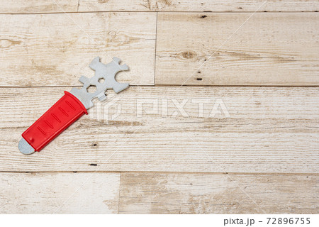 Construction tools on a wood background. Red handle. Lightweight new technology tools. Construction tools on a wood background. Red handle. Lightweight new technology tools. 72896755