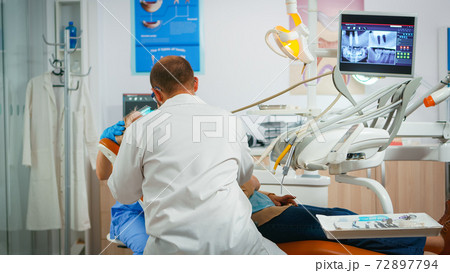 Dentist drilling woman tooth in dental clinic Dentist drilling woman tooth in dental clinic 72897794