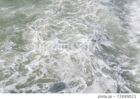 Waves break on the shore. Texture of the water surface near the shore sea natural background. Waves break on the shore. Texture of the water surface near the shore sea natural background. 72899021