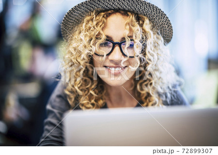 Smart work in travel lifestyle for beautiful trendy caucasian young woman use  laptop computer in bar or airport gate modern alternative free office concept - portrait of pretty female people with 72899307