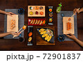 Top view of a couple enjoying Japanese cuisine various side dishes 72901837