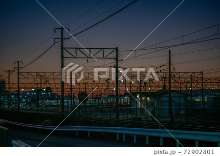 茜色の夕日を背にした架線 72902801