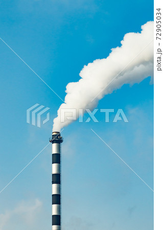 Chimney smoke at factory against blue sky Chimney smoke at factory against blue sky 72905034